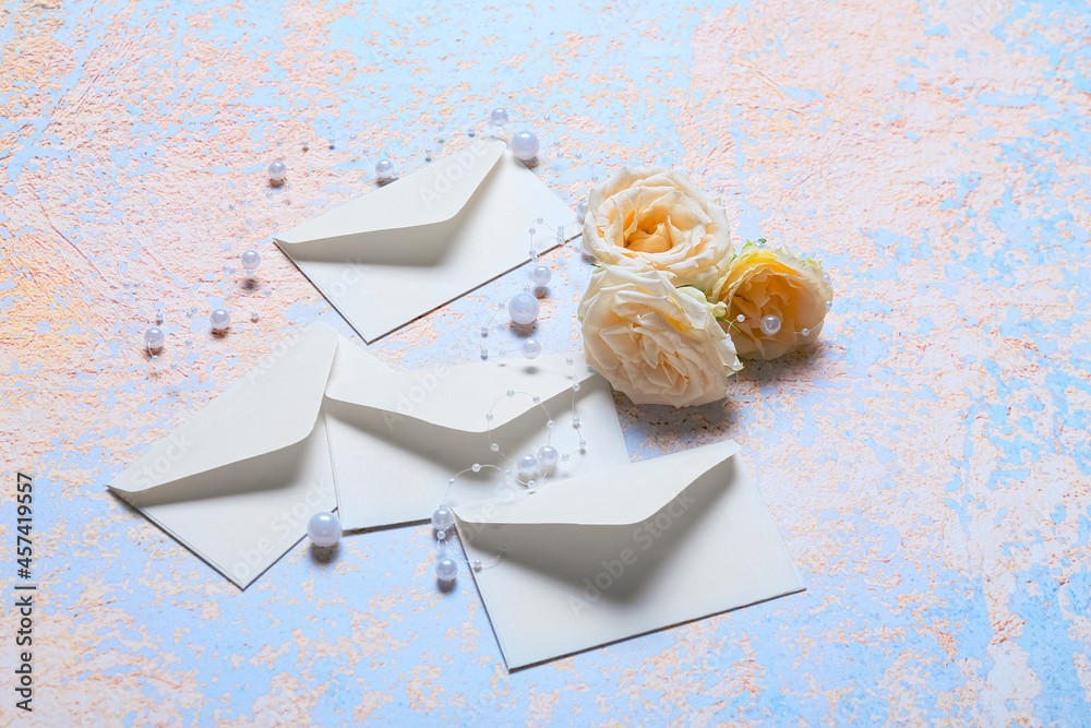 Envelopes with roses and beads on grunge background