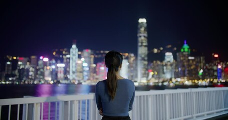 Wall Mural - Woman look at the Hong Kong city at night