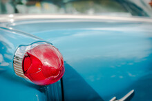 Red Tail Light On Blue Classic Car