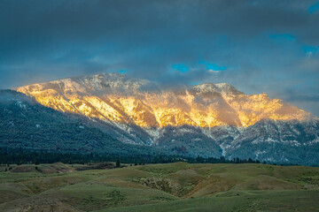 Wall Mural - 2021-06-01 A ABSAROKA MOUNTAIN RANGE WITH LOW CLOUDS AND SUN BREAKING THROUGH IN MONTANA