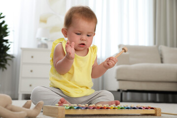 Sticker - Cute little redhead baby playing with xylophone at home