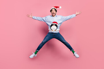 Poster - Photo of attractive funny young man dressed blue christmas pullover jumping like star smiling isolated pink color background