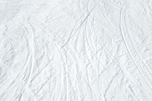 Top View Of White Ski Tracks On Snow Background.
