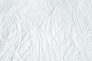 Top view of white ski tracks on snow background.