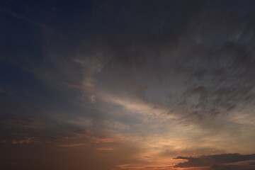 Wall Mural - Cloudy sky in the sunset glow brightly lit orange color
