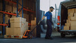 © Gorodenkoff - Outside of Logistics Distributions Warehouse: Diverse Team of Workers use Hand Pallet Truck Start Loading Delivery Truck with Cardboard Boxes, Online Orders, Purchases, E-Commerce Goods.