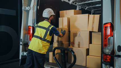 Wall Mural - Handsome Latin Male Worker Wearing Hard Hat Loads Cardboard Boxes into Delivery Truck. Delivering Online Orders, E-Commerce Goods, Food, Medicine Supply. Overworked Tired Frontline Hero Doing Job