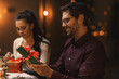 © Syda Productions - holidays, party and celebration concept - happy smiling man with gift box on christmas dinner at home