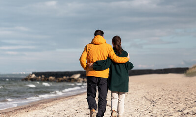 Sticker - love, relationship and people concept - happy couple walking along autumn beach