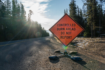 Controlled burn sign along road warning motorists of a prescribed burn area ahead.