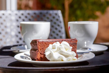 Apricot And Chocolate Sacher Cake With Whipped Cream. Sachertorte Is A Chocolate Cake, Or Torte Of Austrian Origin