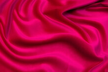 Close-up Texture Of Natural Red Or Pink Fabric Or Cloth In Same Color. Fabric Texture Of Natural Cotton, Silk Or Wool, Or Linen Textile Material. Red And Orange Canvas Background.