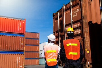 Marine and carrier insurance concept. Two harbor man working at container yard. Foreman control loading Containers box at shipping port. Business logistic Import and export concept.