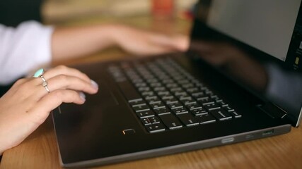 Wall Mural - close up of woman touching laptop fingerprint sensor with her finger to login. biometric fingerprint