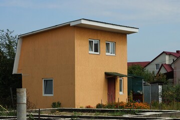 Poster - one brown private house with windows and a door on the street against the sky