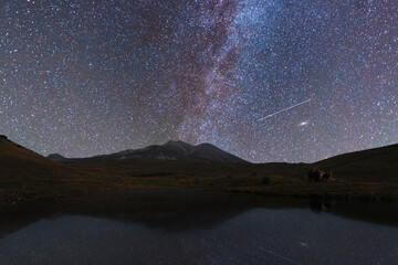 Wall Mural - beautiful night landscape, bright milky way galaxy over lake and mountains. space, astronomical back