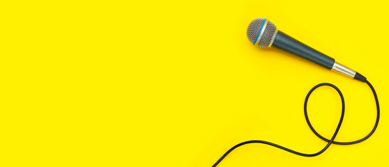 Microphone on yellow background. Top view