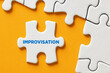 The word improvisation written on a puzzle piece apart form the assembled pieces. Improvising in business decisions