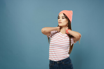 Wall Mural - pretty woman in striped t-shirt pink hat fashion blue background