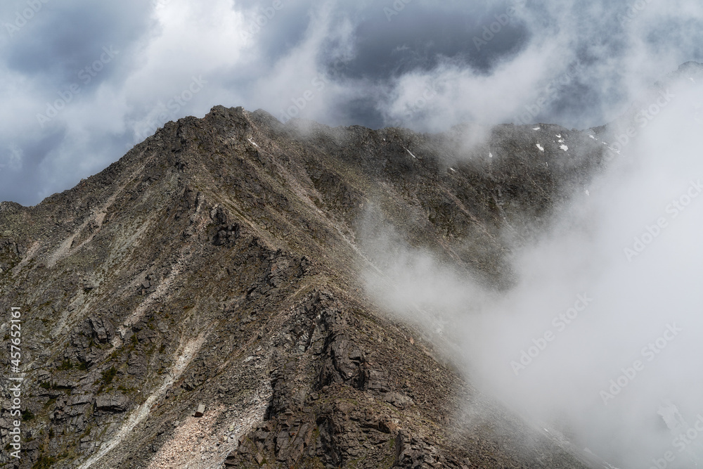 Cloud On Ridges A bald mountain ridge makes its way through thick white clouds ...