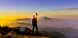 Man Silhouette raise hand up when trek on top mountain at sunset. Silhouette of man climb the peak of mountain hill at sunrise show startup, fight to goal, change to success, leader, challenge concept