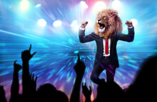 Man With A Lion Head In A Business Suit Celebrating In A Victory Party With Crowd Cheering. Business Leader Success Conceptual Theme.