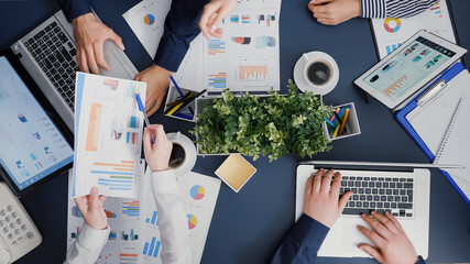 Poster - Top view of business teamwork analyzing company accounting paperwork discussing financial graphs in corporate startup office. Businesspeople planning management strategy expertise brainstorming ideas