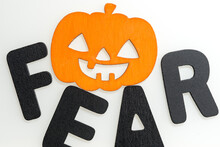 Isolated Orange Jack O Lantern With The Word "fear" In Black Letters On A White Background