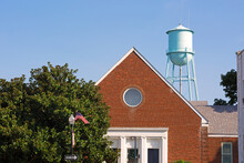 Small Town America Scene With Water Tower And US Flag