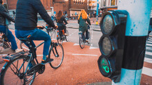 Bikes And Bikers Are Riding In Amsterdam