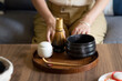 Woman ready for making matcha green tea drink at home using tea ceremony set