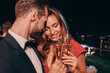 © gstockstudio - Beautiful young couple in formalwear toasting with champagne and smiling