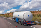 Fototapeta  - Tanker truck for transporting dangerous gases parked on the roadside with a blown out wheel.