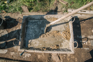 Kneading cement for pouring garden path, garden construction work