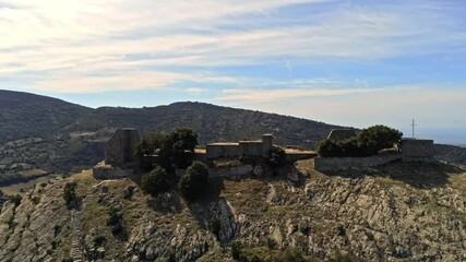 Sticker - A beautiful high angle drone footage of a castle in a thick forest in Sardinia