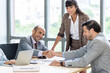 © Pornsak - Businesspeople discussing together in the conference room during meeting at the office.