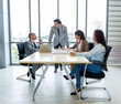 © Pornsak - Businesspeople discussing together in the conference room during meeting at the office.