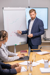 Aufkleber - Young serious businessman pointing at graph on whiteboard and looking at economists during presentation