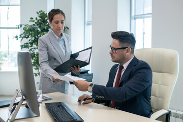 Aufkleber - Boss in elegant suit and eyeglasses passing documents to his secretary after signing