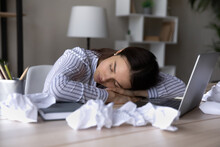Exhausted Businesswoman Or Student Sleeping At Desk With Crumpled Papers Documents, Feeling Tired, Overworked Young Woman With Closed Eyes Lying On Table After Difficult Working Day, Lack Of Energy