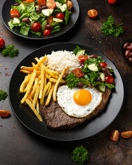 Wall Mural - Portugal dish Bitoque made from beef steak with a fried egg, rice, french fries and vegetables