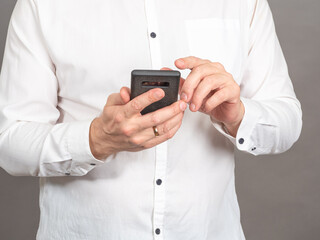 Poster - Person with smartphone. Man hands with mobile phone close up. Businessman using smartphone. Search for information or social networks concept. Hipster person types an SMS message to his friends.