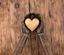 Wooden Heart In The Hands Of A Mannequin