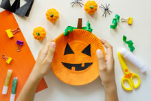 Cuts Of Paper For Halloween. Hand Cut Paper. Pumpkins. Scissors And Glue. On A Light Background. Top View. Flat Lay. DIY. Step By Step. Trick Or Treat.