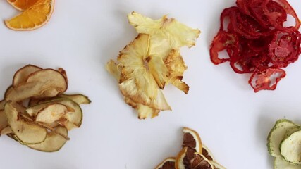 Wall Mural - A healthy food snack. A bunch of sun-dried crunchy and fruit. Dehydrated slices of fruit chips. Assorted Dried Fruits close-up. Snacks from dried fruits. dried apples, oranges, lemons, kiwis top view.