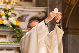 Fototapeta Miasta - The Holy Bread in the rite of Eucharist
