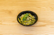 take away bowl with ravioli stuffed with meat with pesto sauce, grated cheese basil with pine nuts
