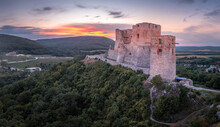 Aerial View Of Ruined Gothic Csesznek Castle In The Bakony Region Of Hungary In Veszprem County With Old Palace Building, Gate Tower With Colorful Dramatic Sunset