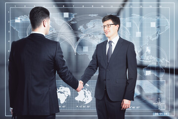 Aufkleber - Two attractive happy young european businessmen shaking hands in blurry office interior with glowing map hologram. Communication, global trade and teamwork concept. Double exposure.