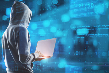 Wall Mural - Hacker in hoodie using laptop with abstract glowing blue coding background. Binary code, theft, technology, data and internet concept. Double exposure.